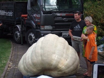 The Pumpking with his son, the mayor and his record-winning 808kg pumpkin.
