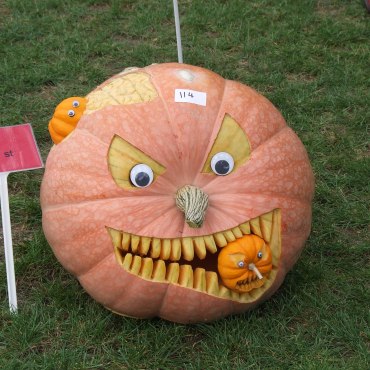 A kinda creepy but skillfully carved pumpkin.